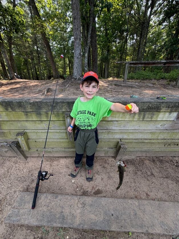 Scout practicing at the wooded archery range